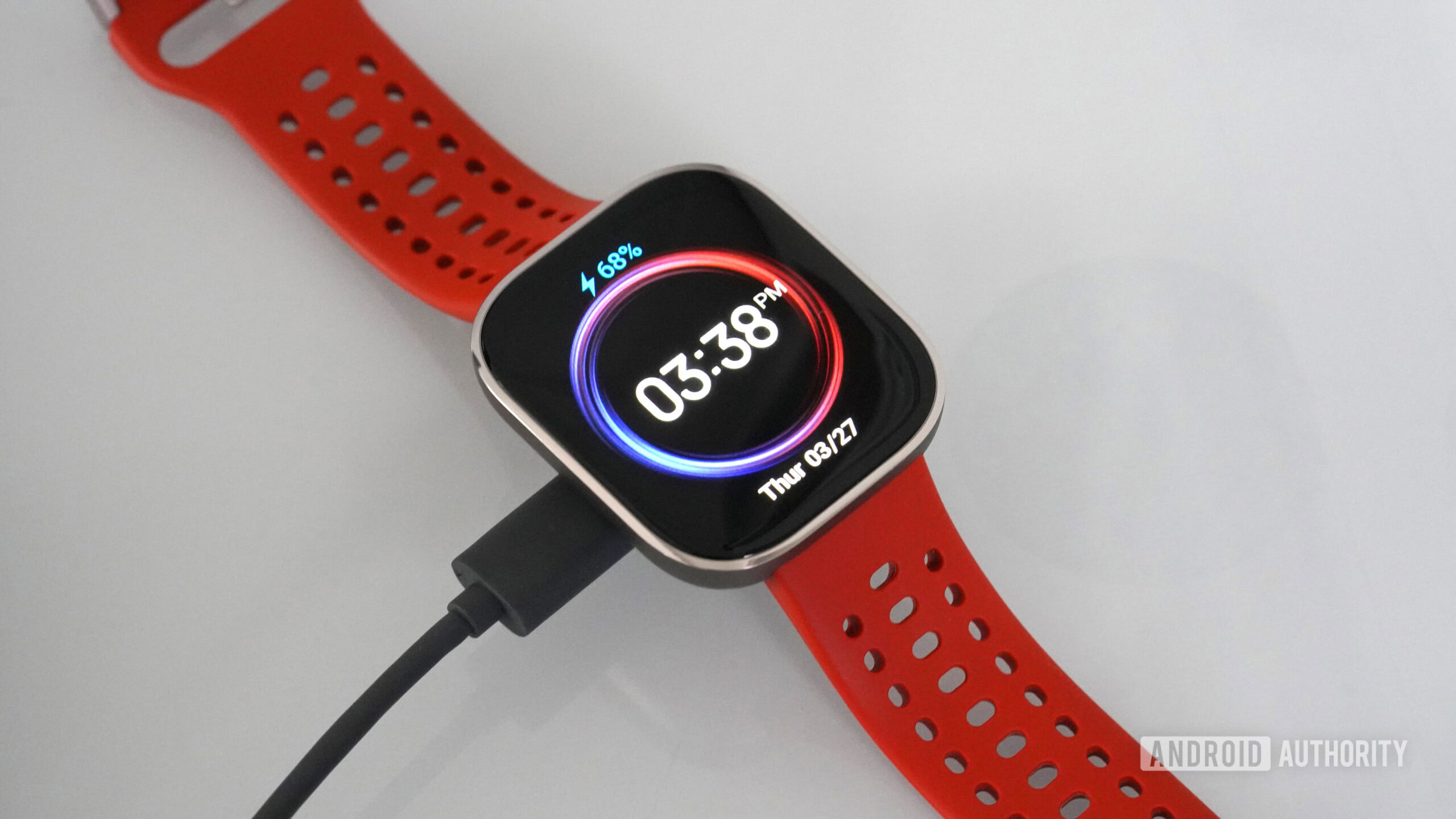 Amazfit Bip 6 Charging An Amazfit Bip 6 rests on its charger.