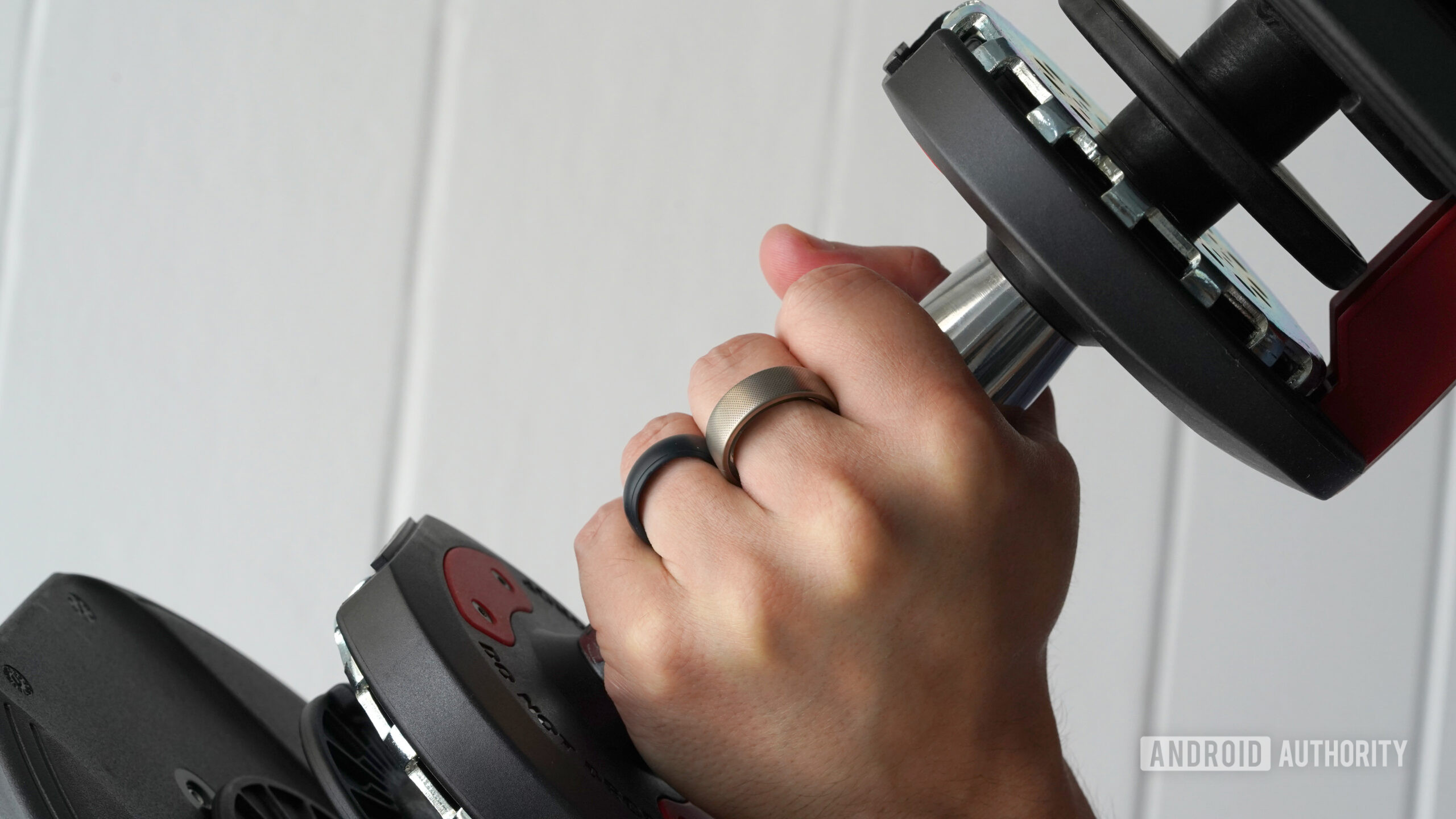 Amazfit Helio Ring Hand Weight A user attempts to weight lift wearing an Amazfit Helio Ring.