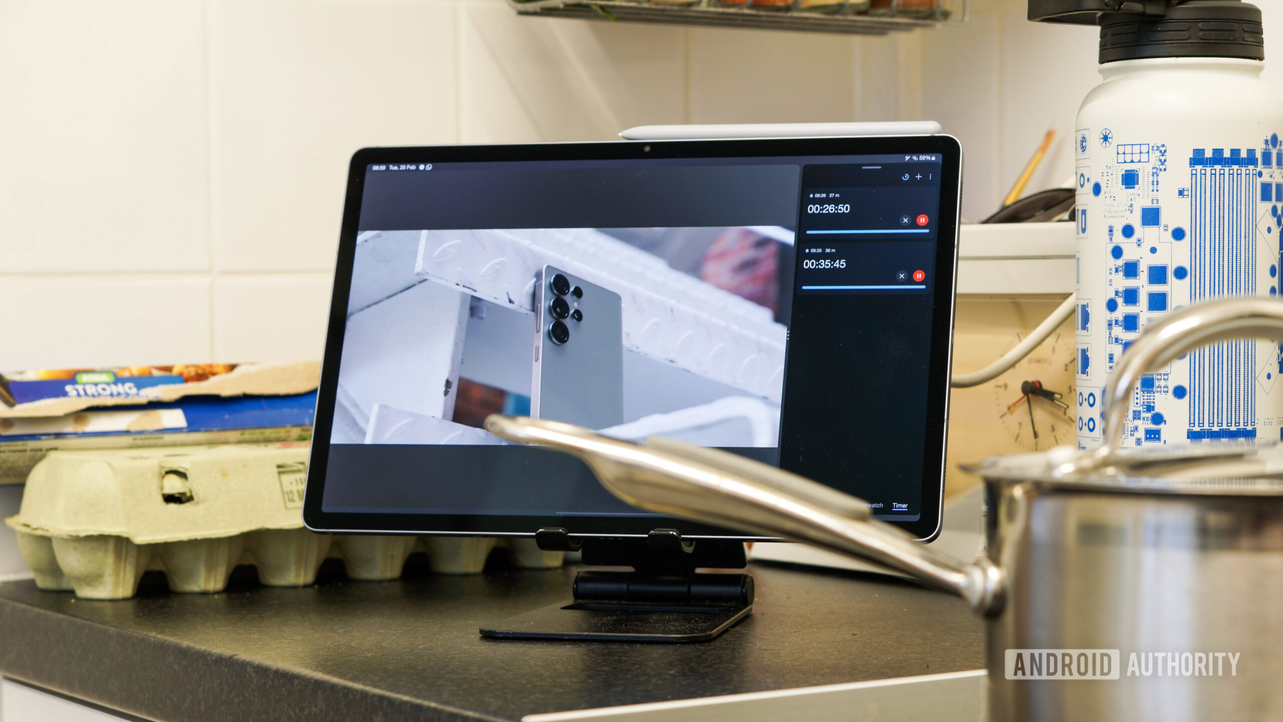 A photo of a Galaxy Tab S10 Plus being used in a kitchen, running timers and playing video