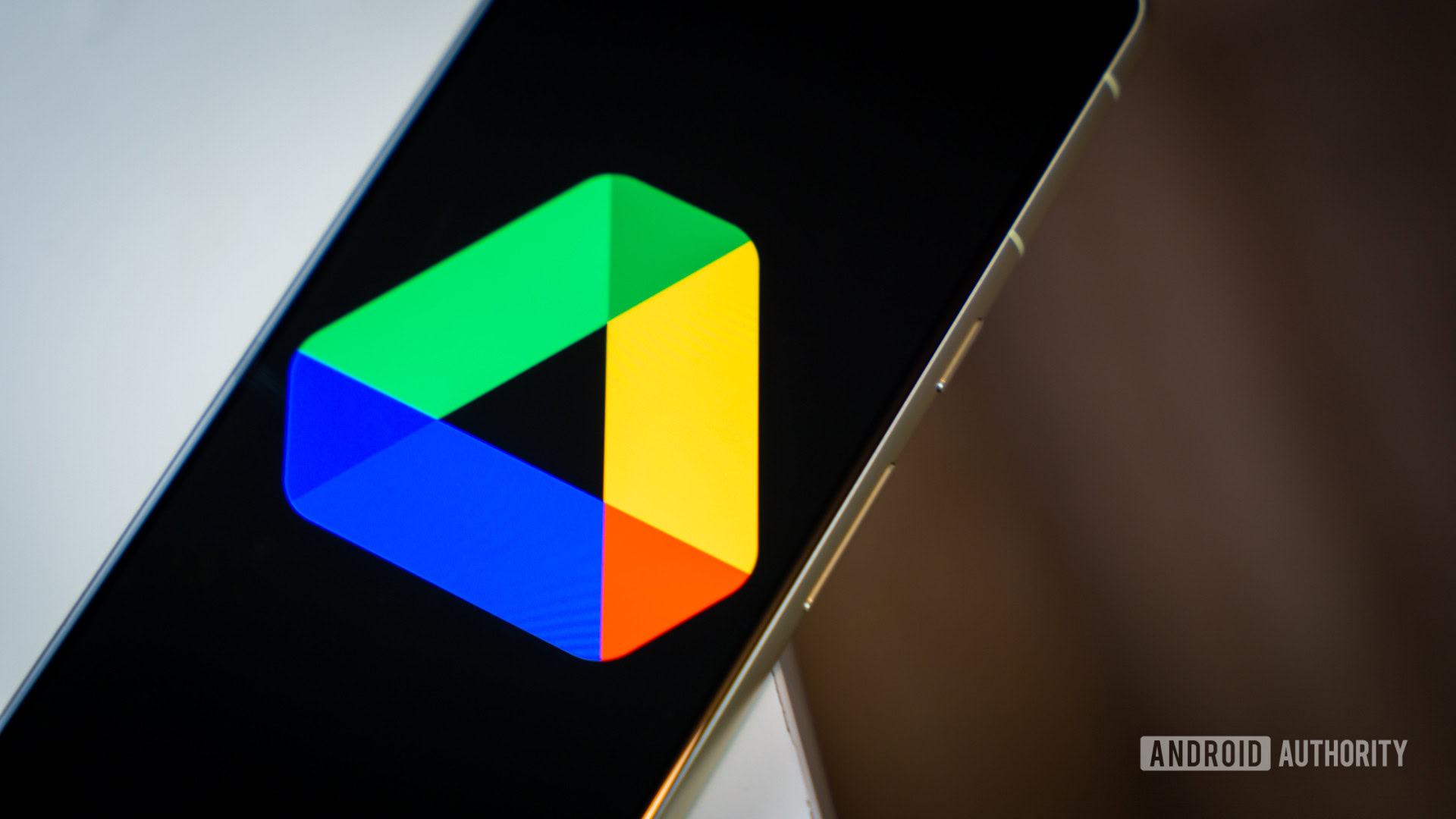 Google Drive logo on smartphone laying on desk Stock photo 2 Google Drive logo on smartphone laying on desk Stock photo 2