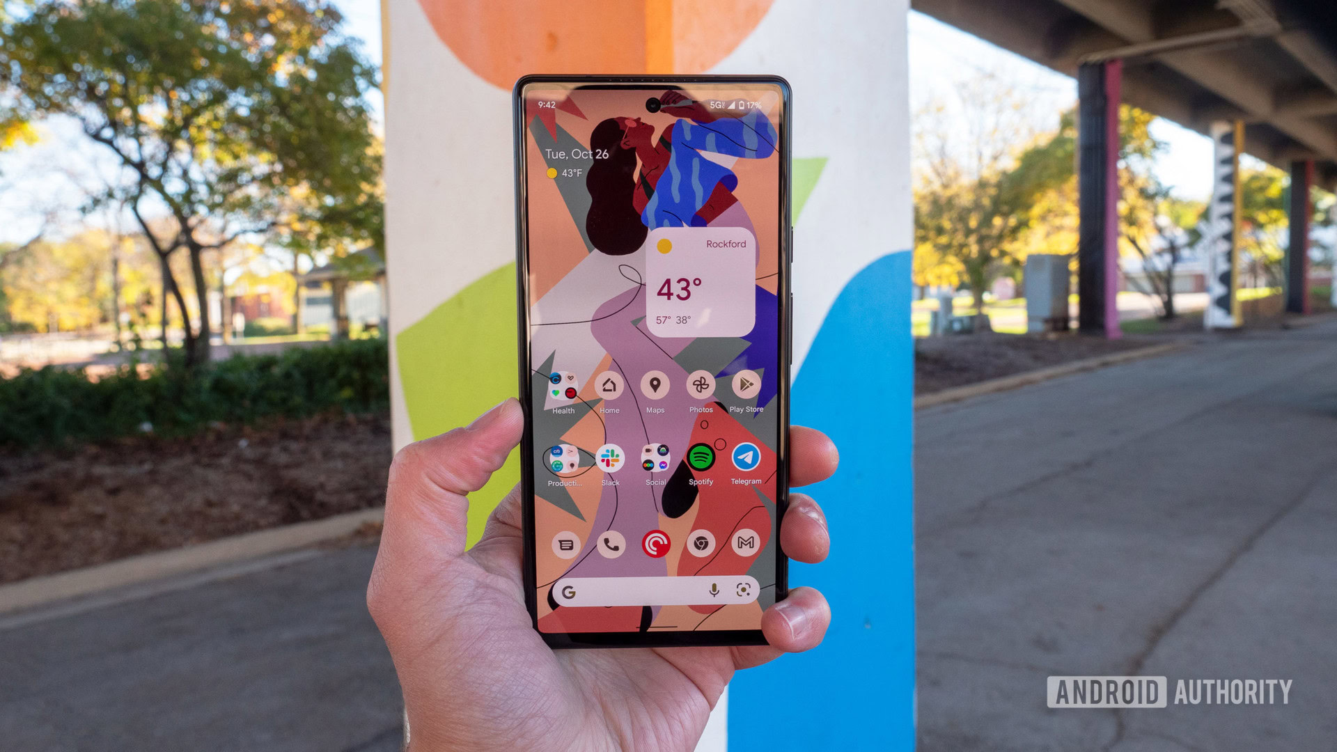 google pixel 6 review sorta seafoam in hand software home screen android 12 The Google Pixel 6 in Sorta Seafoam color in hand showing the home screen and display