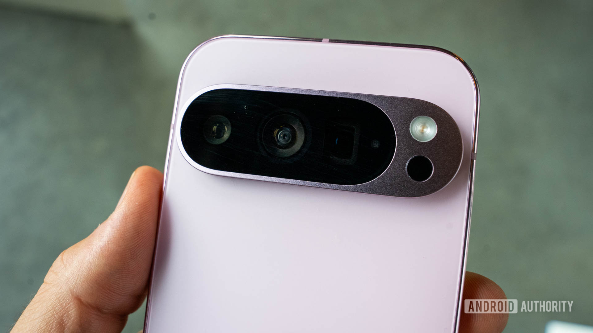 Google Pixel 9 pro in Rose Quartz with a close up on its rear camera module Google Pixel 9 pro in Rose Quartz with a close up on its rear camera module