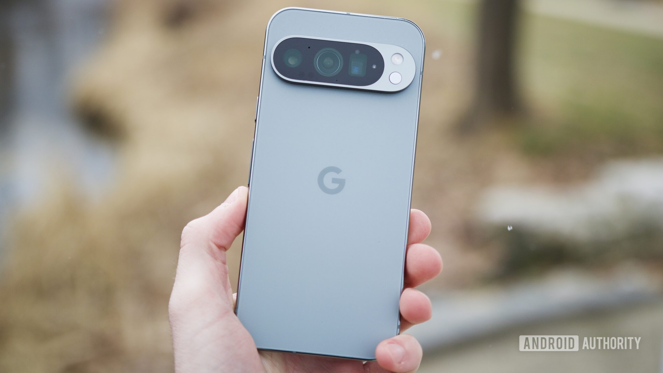 google pixel 9 pro revisit 1 Someone holding the Google Pixel 9 Pro outside.