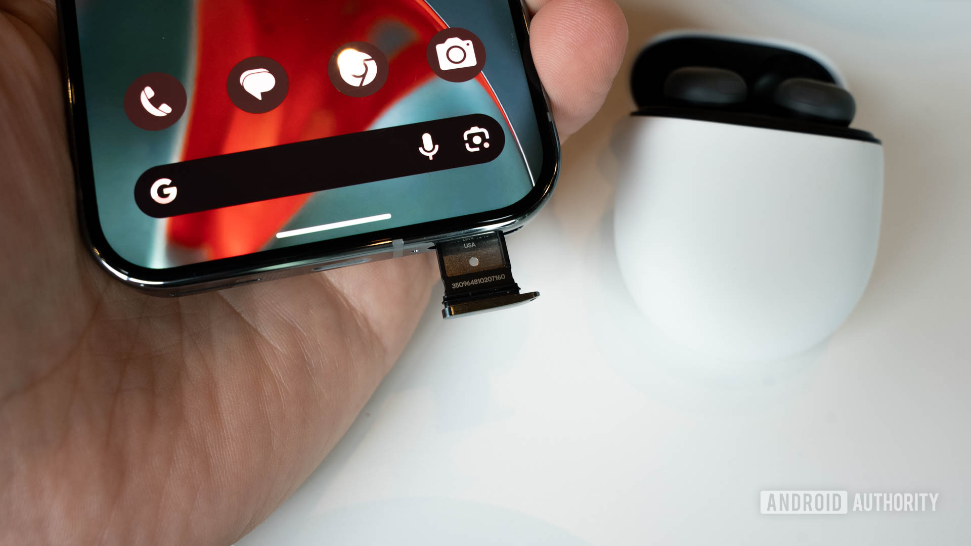 Google Pixel 9 Pro with its SIM tray sticking out slightly Google Pixel 9 Pro with its SIM tray sticking out slightly