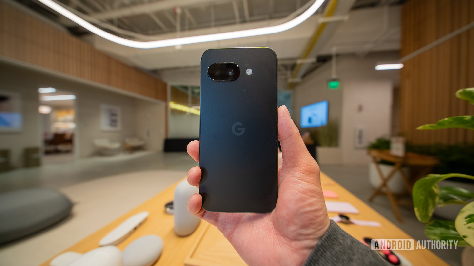 Google Pixel 9a black rear in hand Google Pixel 9a black rear in hand