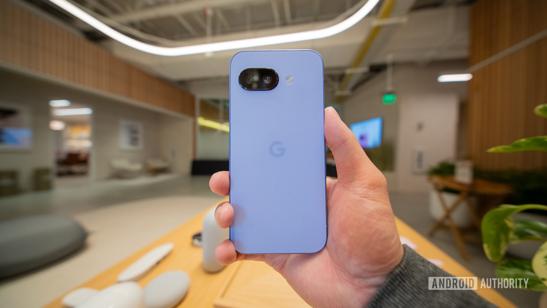 Google Pixel 9a iris rear in hand A user holds a Google Pixel 9a in Iris.