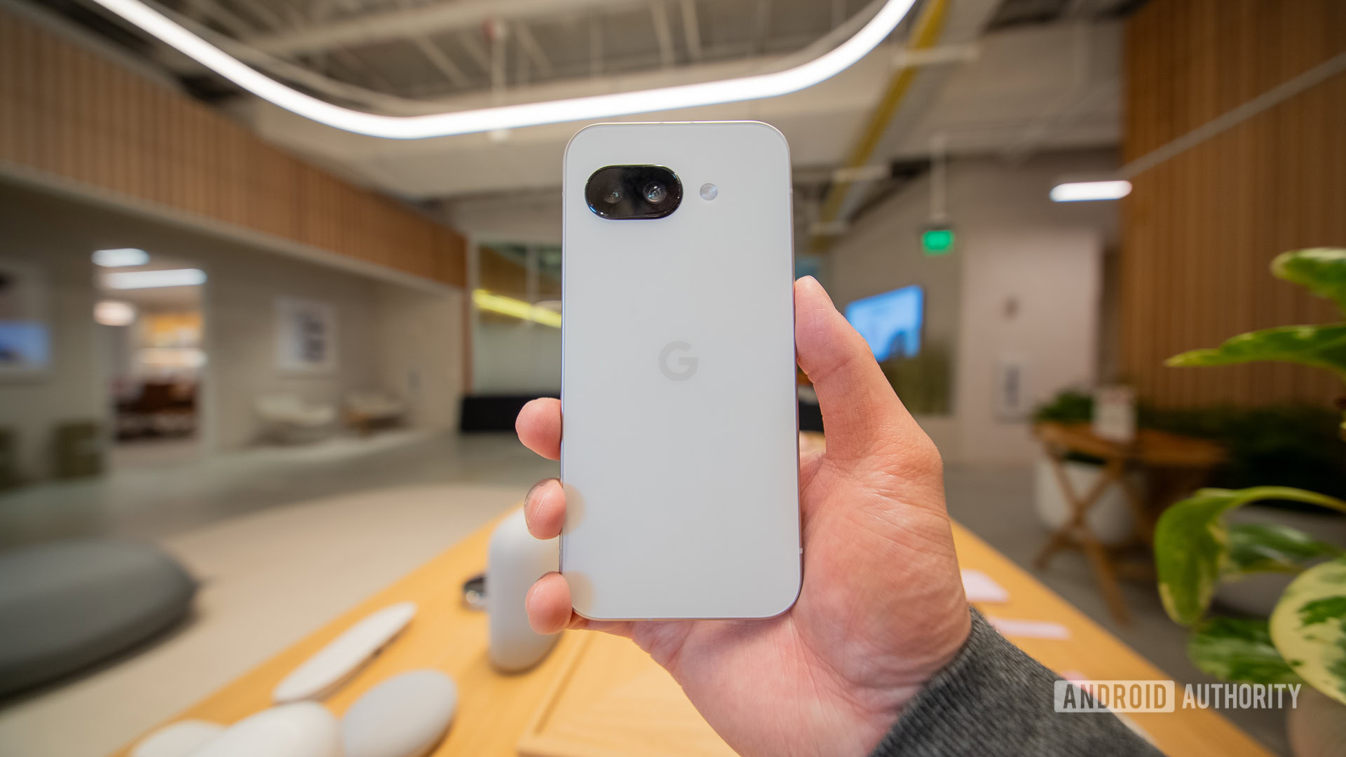 Google Pixel 9a white rear in hand Google Pixel 9a white rear in hand