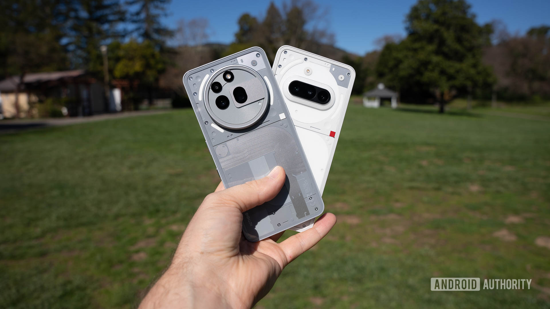 Nothing Phone 3a and Phone 3a Pro fanned in a man's hand Nothing Phone 3a and Phone 3a Pro fanned in a man's hand