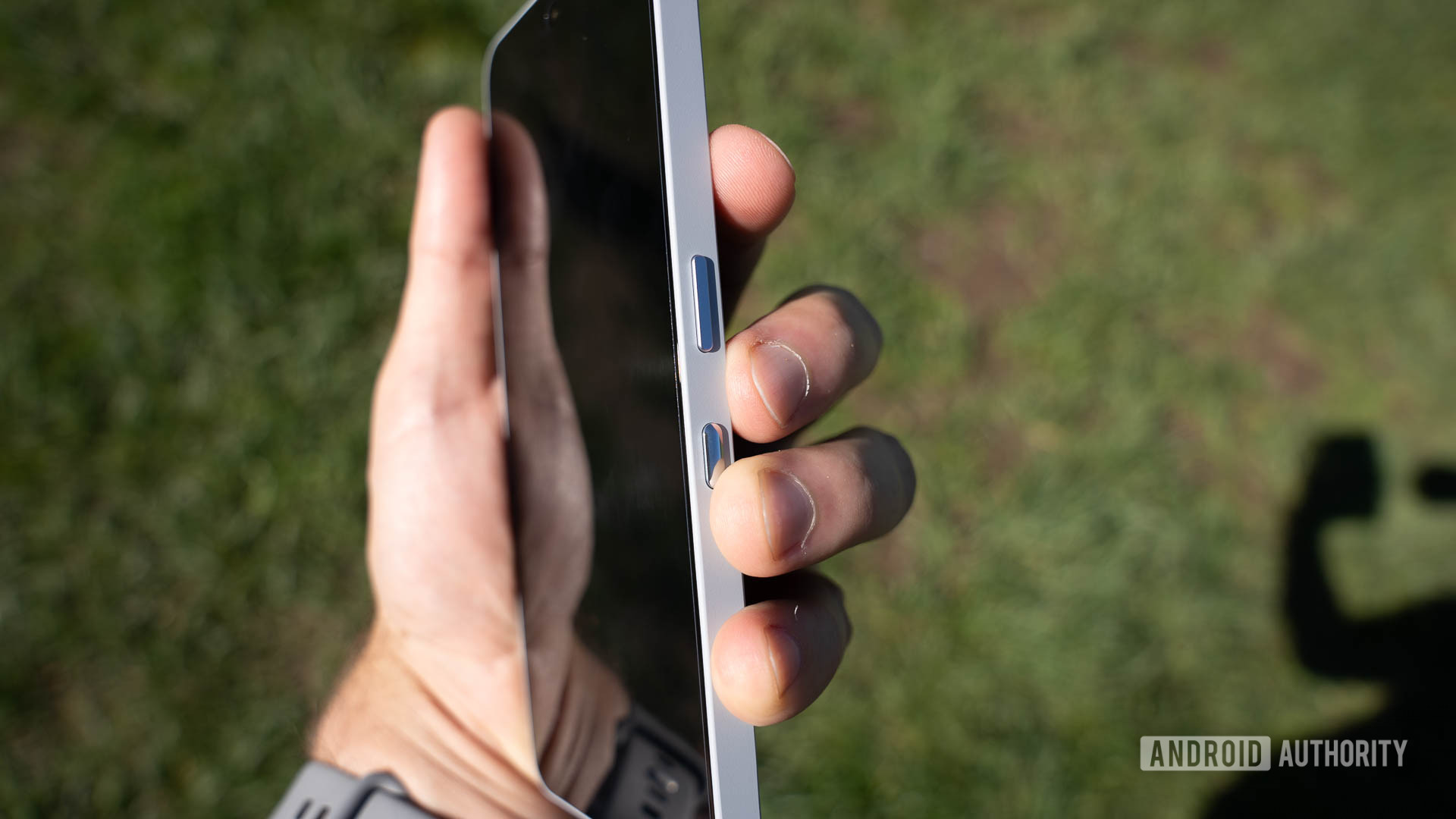 Nothing Phone 3a Pro power button and Essential Key with man's fingers Nothing Phone 3a Pro power button and Essential Key with man's fingers