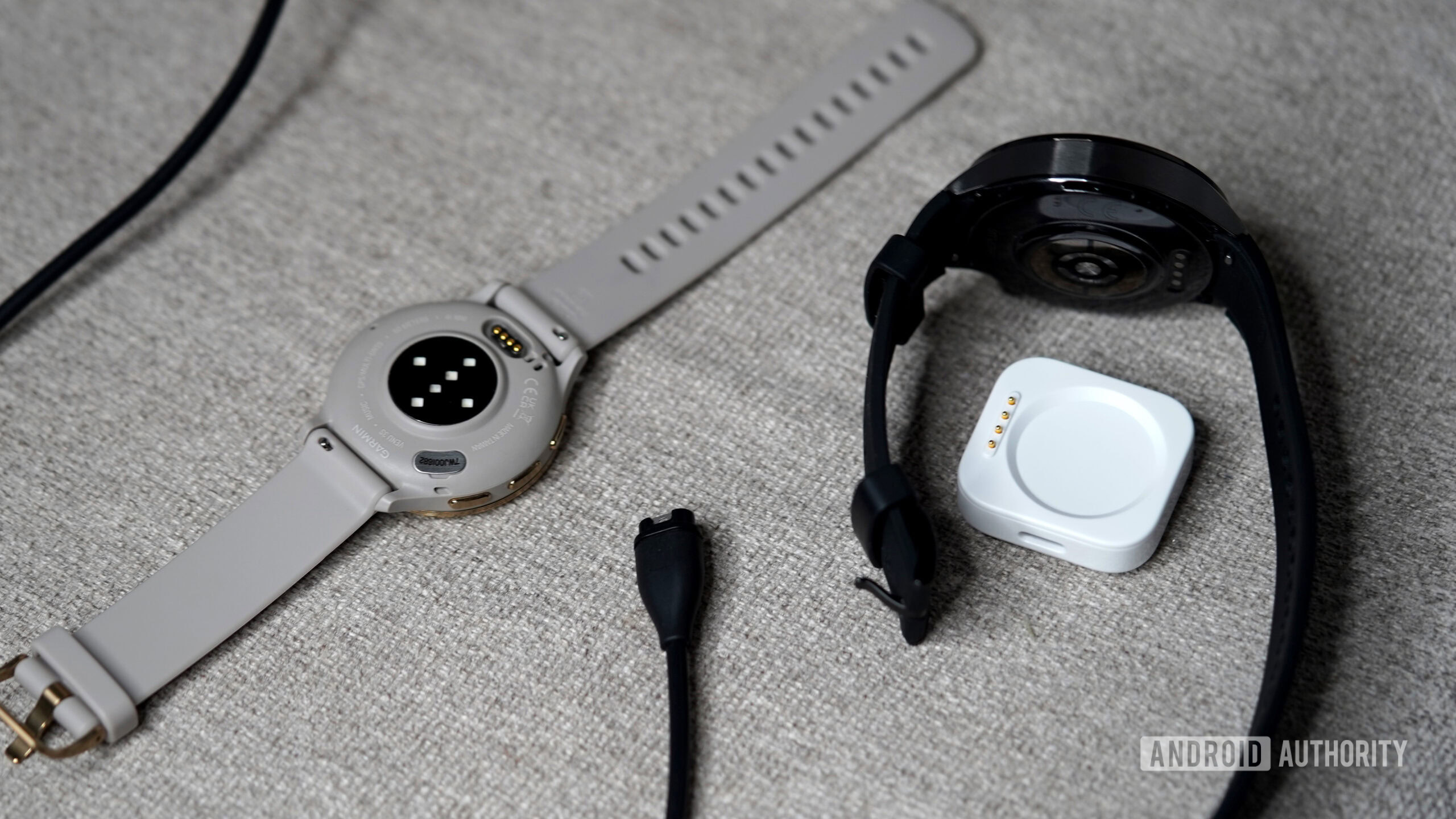 OnePlus Garmin Charger A OnePlus Watch 3 and Garmin Venu 3 rest alongside their chargers.