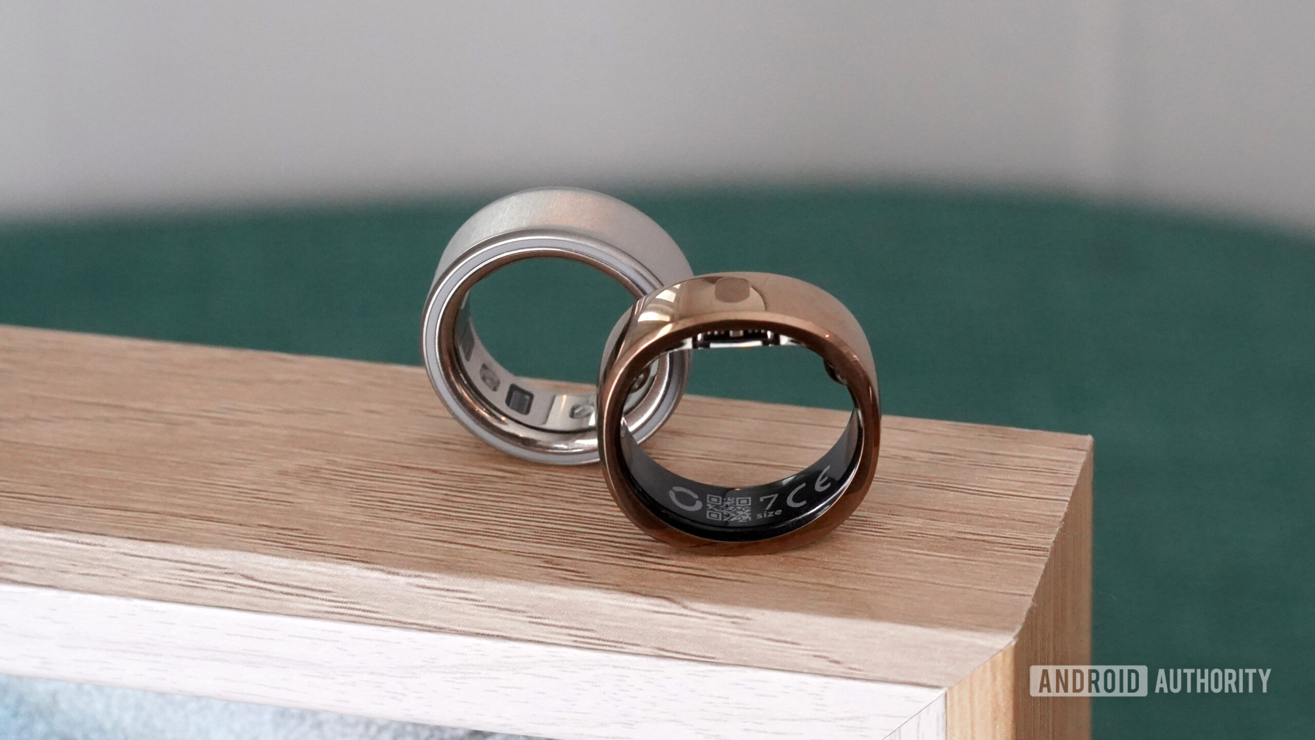RingConn Gen 2 Air vs Oura Ring 4 A RingConn Gen 2 Air on its edge rests alongside an Oura Ring 4.