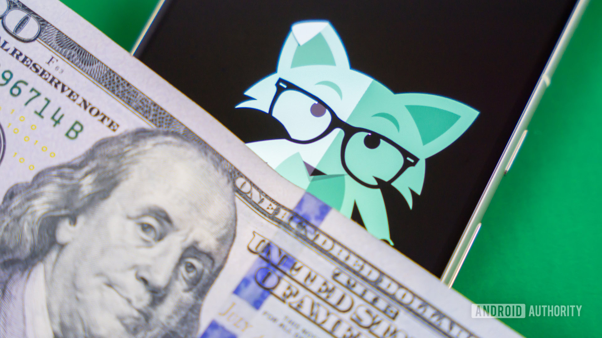 Stock photo of Mint Mobile fox on phone with money 2 Stock photo of Mint Mobile fox on phone with money 2