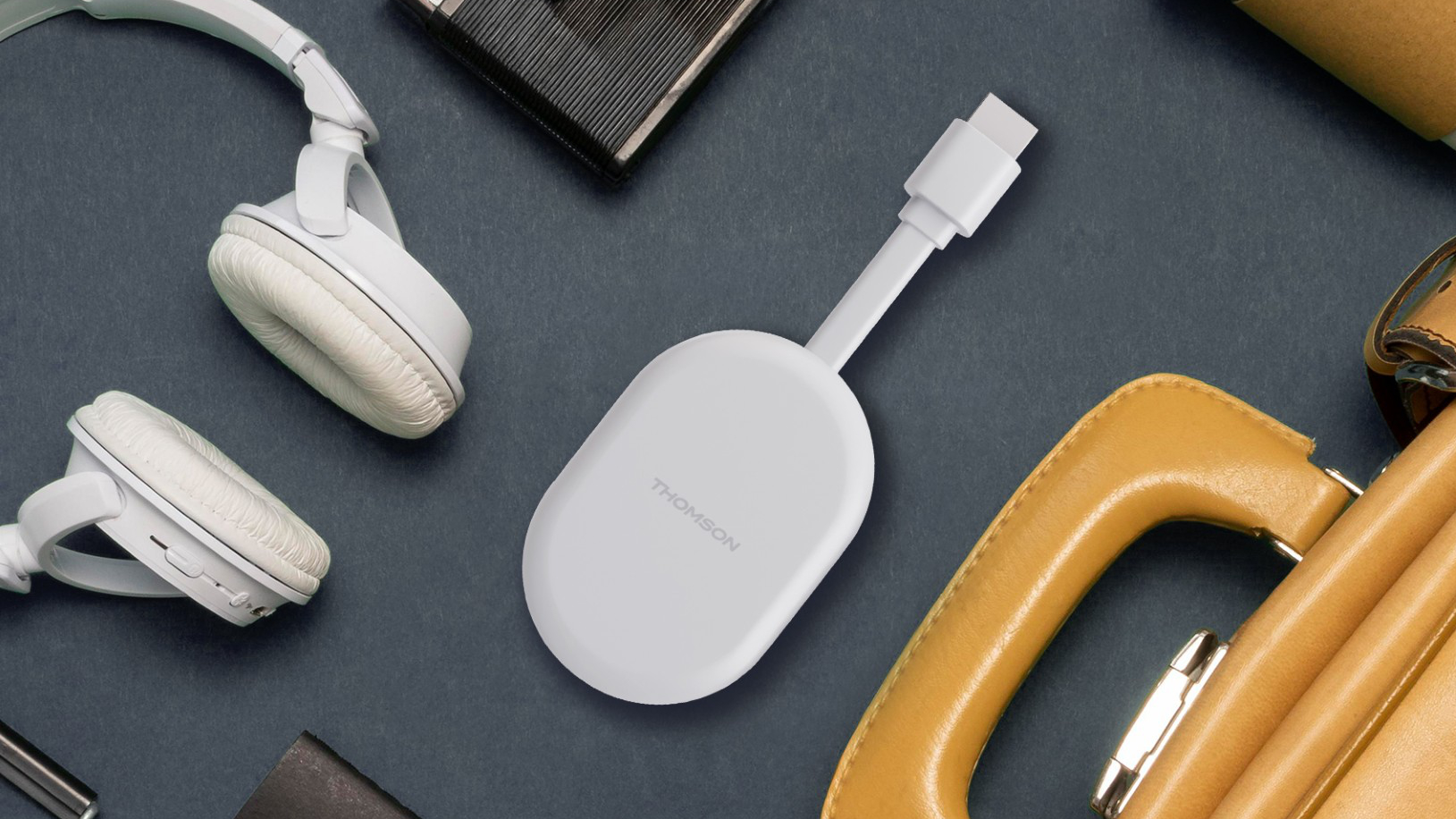 A lifestyle photo of the Thomson Cast 150 Google TV streaming dongle.